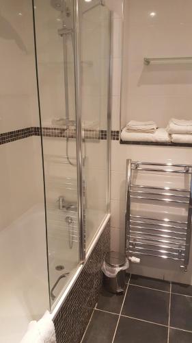 a bathroom with a shower and a glass shower stall at Stone House Hotel ‘A Bespoke Hotel’ in Stone