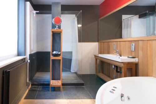 a bathroom with a shower and a sink at App De Panne 1 in De Panne