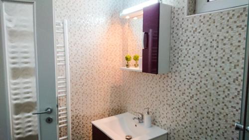 a bathroom with a sink and a medicine cabinet at Autumn Bliss Apartment in Timişoara