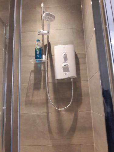 a shower in a bathroom with a soap dispenser at Lake Street Studios in Oxford