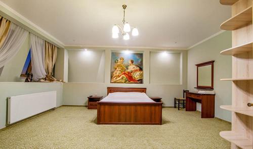 a bedroom with a bed and a desk and a painting at Veles Hotel in Dnipro