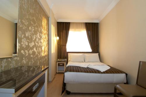 Un ou plusieurs lits dans un hébergement de l'établissement Soyic Hotel