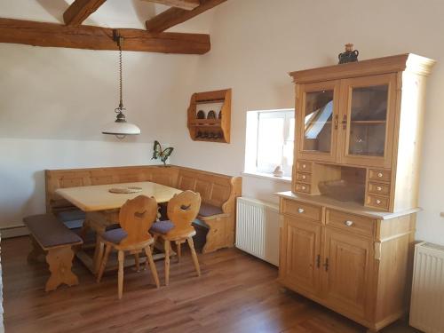 a kitchen with a table and chairs and a cabinet at Ferienwohnung "Zum Hexenhäusle" in Weißenburg in Bayern