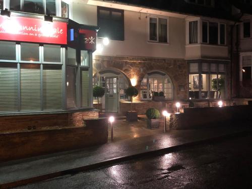 a building on a street at night with lights at The Sunningdale in Bamburgh