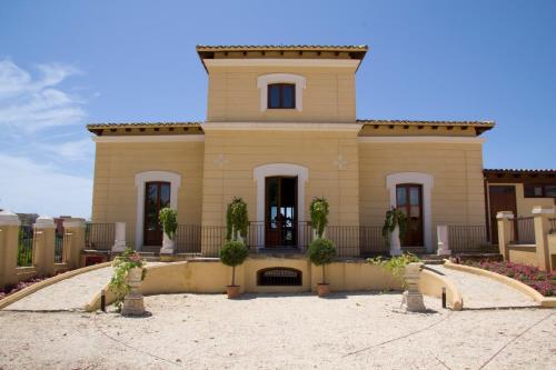 a large house with plants in front of it at Hotel Villa Calandrino in Sciacca