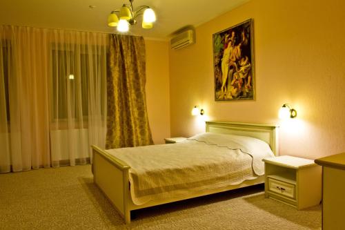 a bedroom with a bed and a window at Veles Hotel in Dnipro