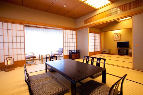 a dining room with a table and chairs at Ranzan in Kyoto
