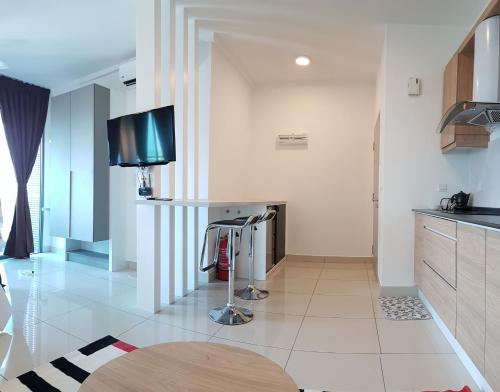 a kitchen with a flat screen tv on a counter at EVO SOHO STUDIO Suites in Kampong Sungai Ramal Dalam