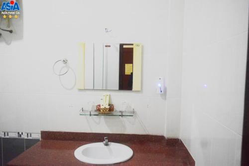 a bathroom with a sink and a mirror at Asia Hotel Can Tho in Can Tho