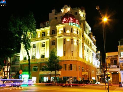 a large building with a sign on it at night at Asia Hotel Can Tho in Can Tho