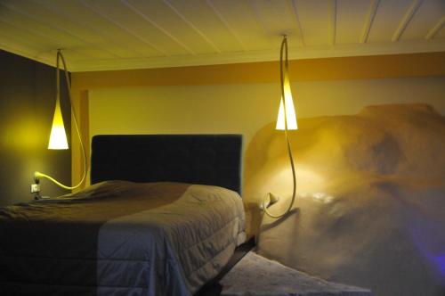 a bedroom with a bed and a light on the wall at Amfitriti Palazzo in Nafplio