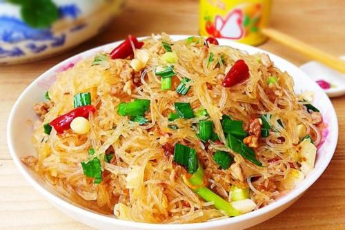 a bowl of food with noodles and vegetables on a table at Asia Hotel Can Tho in Can Tho