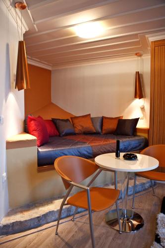 a living room with a couch and a table and chairs at Amfitriti Palazzo in Nafplio