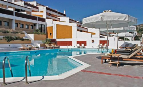 a swimming pool in front of a building at Mare Vista Hotel - Epaminondas in Batsi
