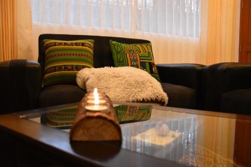 a living room with a couch and a glass table at Boutique Amaru Wasi in Cusco