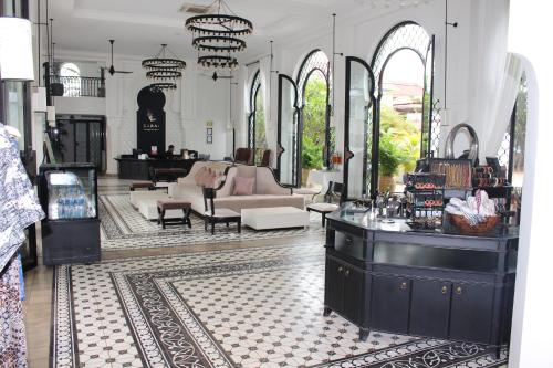 a room with a salon with a couch and a table at Sarai and Wander Resort in Siem Reap