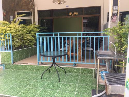 a table and two chairs on a patio at Baan AomSub in Ko Samed