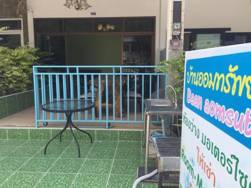 a table and chairs in front of a building at Baan AomSub in Ko Samed