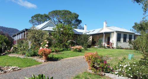 a house with a garden in front of it at The Old School Bed and Breakfast in Wolumla South