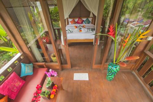 an overhead view of a room with a bed and flowers at Ratna Villa 4 in Ubud