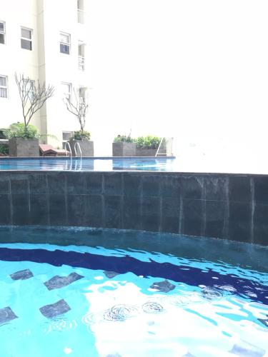 a swimming pool with turtles in the water at Sam’s Parahyangan Residence in Bandung