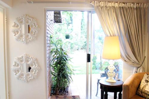 a living room with a door open to a patio at 513 on Mulberry in Pretoria