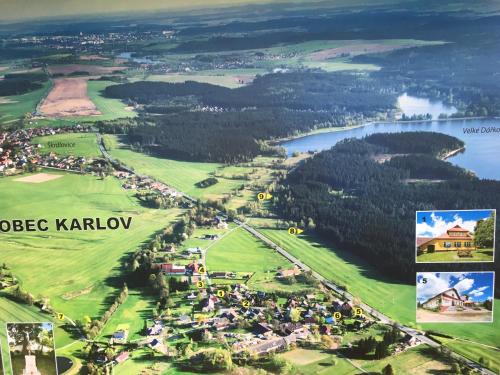 an aerial view of a golf course with a lake at Penzion Karlov in Karlov
