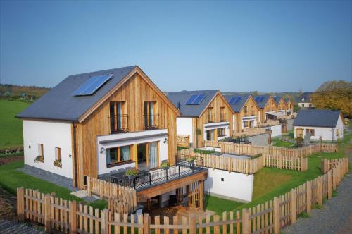 a row of houses with solar panels on their roofs at Chalets Petry Spa & Relax in Bettel
