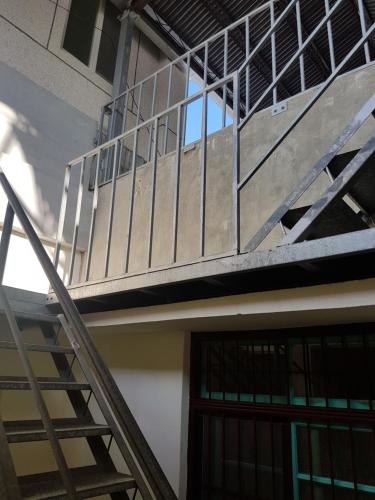 a stairway leading up to a building with a balcony at 履舍民宿Footinn in Taitung City