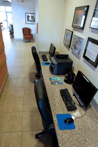 an office with a desk with a computer and chairs at Garden Place Suites in Sierra Vista