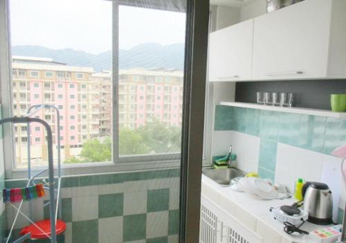 a kitchen with a sink and a window at DAO Studio Apartments in Patong Beach