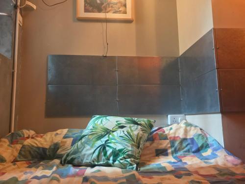 a bedroom with a bed with a blackboard on the wall at Wontonmeen in Hong Kong