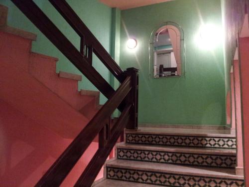 a staircase in a house with a mirror at Hotel La Giralda in Nador