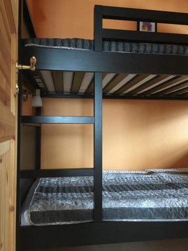 two bunk beds in a room with a bed at Valla Stuga in Kristinehamn