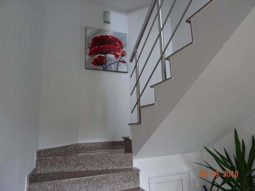 una escalera en una casa con una pintura en la pared en House Rezvaya with rooms for rent, en Rezovo