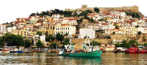 a group of boats in a harbor with a city at TETYK Keramoti Hotel Apartments in Keramotí