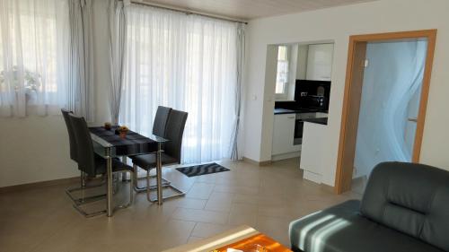 a living room with a table and chairs and a kitchen at "Schoene Aussicht" in Burgen