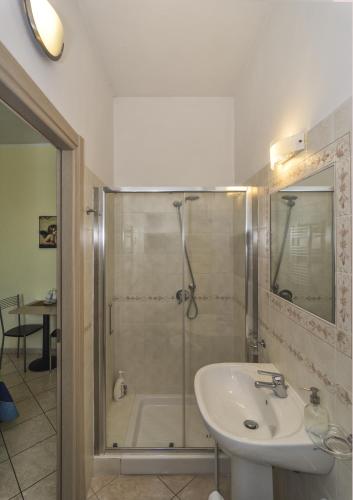 a bathroom with a shower and a sink and a tub at Affittacamere Elisa in Pisa