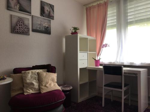 a room with a desk and a chair and a table at Apartments in Bern - Breitenrainplatz in Bern