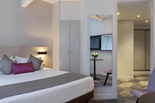 Postel nebo postele na pokoji v ubytování Citadines Trocadéro Paris