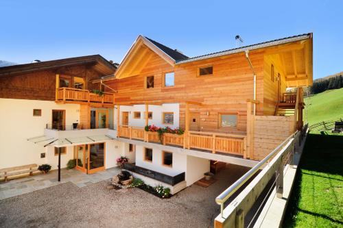 an aerial view of a wooden house with a balcony at Hotel Naturoase Schwemmerhof in Ultimo