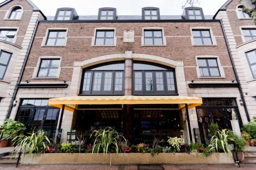 an old brick building with a large window at House Belfast Hotel in Belfast