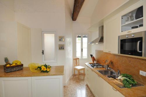 a kitchen with a sink and a counter top at Ca' dell' Artista with Balcony and Terrace in Venice