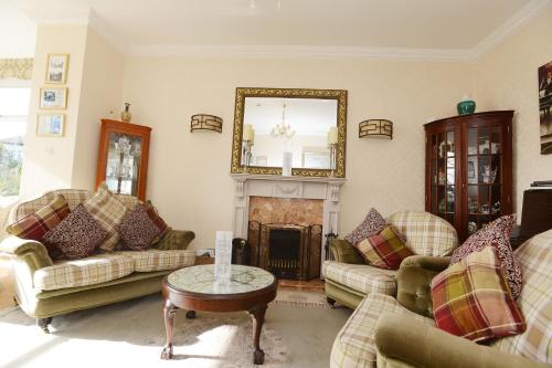 a living room with couches and a fireplace at The Cleveland in Torquay