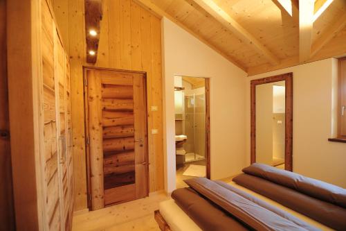 a room with wood paneling and a door with a mirror at Hotel Naturoase Schwemmerhof in Ultimo