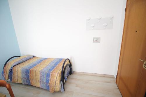 a bedroom with a bed with a colorful blanket on it at Trilocale Rivabella in Gallipoli
