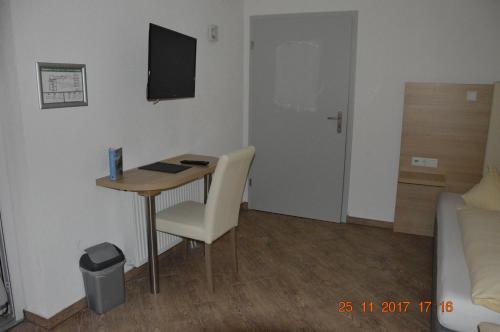 a small room with a desk and a bed at Hotel Mezzero in Waldshut-Tiengen