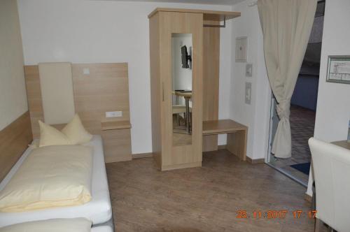a small room with a bed and a television at Hotel Mezzero in Waldshut-Tiengen