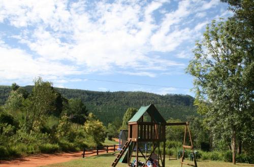 a playground with a swing set in a park at Sabie Star in Sabie