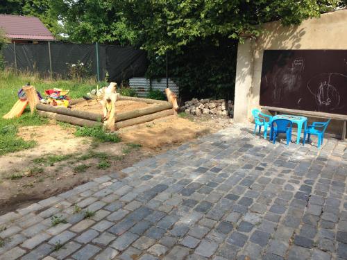 a playground with two blue chairs and a chalkboard at Restaurace U Kostela in Mariánské Radčice